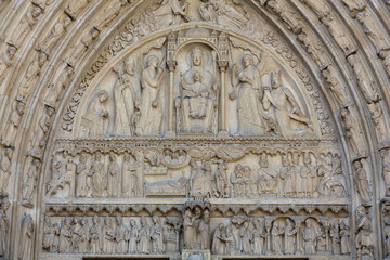 Paris - West facade of Notre Dame Cathedral. The Saint Anne portal and tympanum