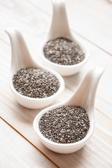 heap of chia seeds, on white wooden board