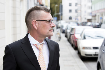 portrait of businessman standing in the street