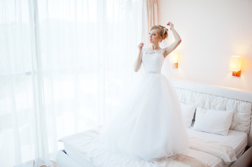 Obraz premium gentle blonde bride on couch tenderly posed
