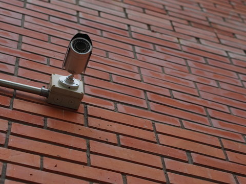 A close circuit television (CCTV) install on a brick wall for security