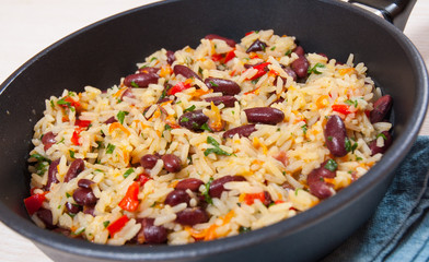 Rice with red beans and vegetables in a frying pan
