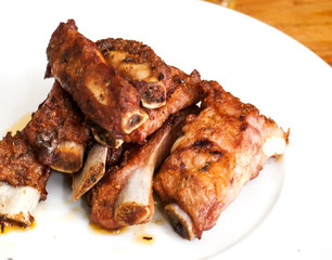 Roasted pork ribs on a white plate