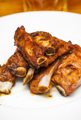 Roasted pork ribs on a white plate
