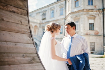 Tender wedding couple background old architecture of castle