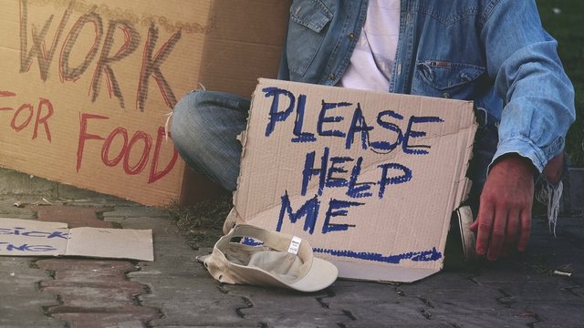 Homeless beggar asking for help, adult man begging on the street.