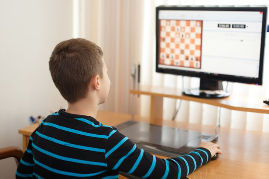 Little Boy Play Online Chess At Home