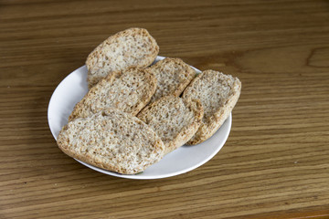 crispy bread on white dish on wood background