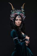 Beautiful fantasy elf woman in floral crown and medieval dress