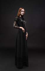 Portrait of gothic girl with black eyes in dark clothes