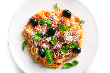 Pasta Bolognese with parmesan and basil on light background