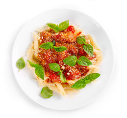 Pasta with tomato sauce and basil isolated on white