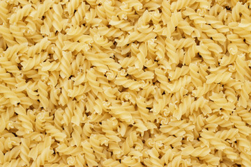 close-up of dry uncooked rotini texture background