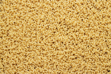 dry uncooked cavatappi pasta texture background