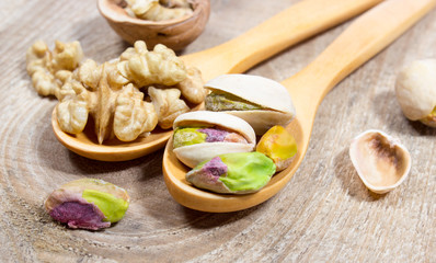 Closeup of a walnut and pistachios.