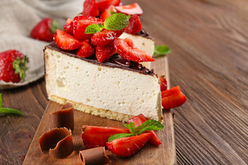 Delicious cheesecake with berries on table close up