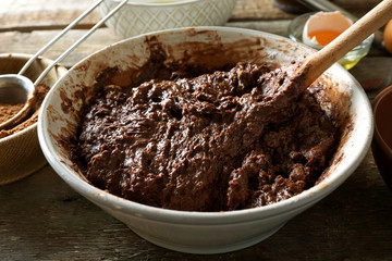 Preparing dough for chocolate pie on table close up