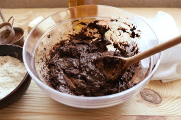 Preparing dough for chocolate pie on table close up