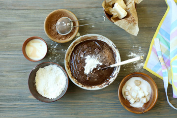 Preparing dough for chocolate pie on table close up