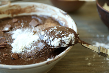 Preparing dough for chocolate pie on table close up