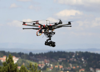 Fototapeta na wymiar A drone with a camera flying high