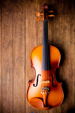 Violin on wood background. Top view.