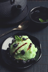 Homemade Green tea ice-cream on bamboo mat, on wooden background