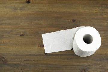 toilet paper on a wooden background