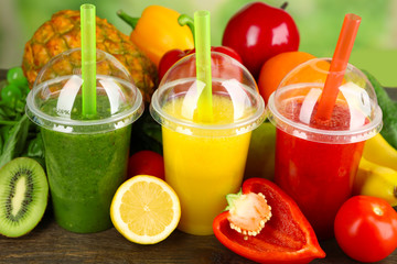 Fresh juice mix fruit, healthy drinks on wooden table, on bright background