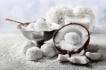 Homemade Candies in coconut flakes and fresh coconut on light background