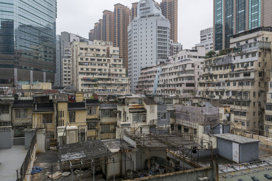 The roof tops and facades of old apartment buildings in Hong Kong