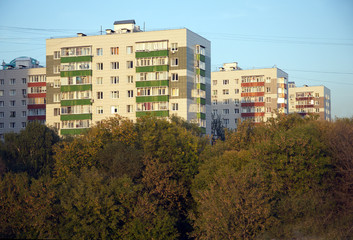 Fototapeta na wymiar Houses in a residential district after major overhaul of deep trees in early autumn day
