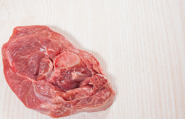 Food background of raw meat at the wooden board with copy space