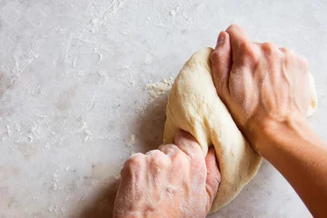 Fotobehang Hands kneading dough © mizina
