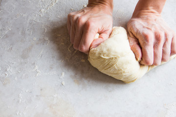 Hands kneading dough