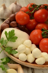 Plate of tomatos, olives and mozarella cheese