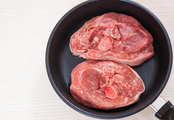 Raw meat  in a frying pan