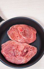 Raw meat  in a frying pan