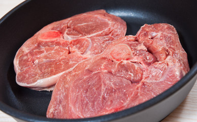 Raw meat  in a frying pan