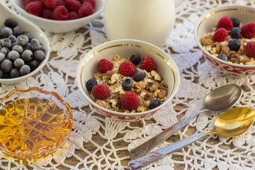 Homemade granola with raspberries, blueberries, walnuts and hone