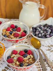 Homemade granola with raspberries, blueberries, walnuts and hone