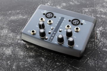 Audio interface for recording or mixing - sound/audio card - cables for guitar and other instruments on grunge background