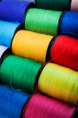 colorful threads on spools