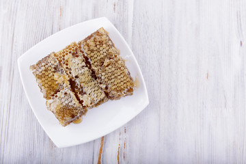 honeycombs on white wooden background