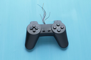 Old joystick on blue background