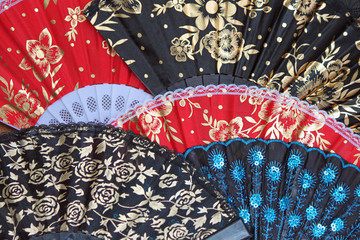 Display of Colorful Oriental Fans with Gold Flowers and Sequins
