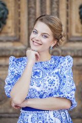 Fototapeta na wymiar Portrait of young blonde woman in blue dress