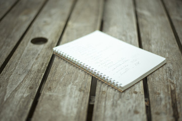 blur of vintage paper notebook on wood background