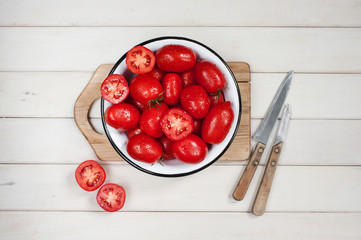 Ripe tomatos in the white bowl