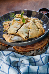 Close-up closed italian pizza calzone on the wood table